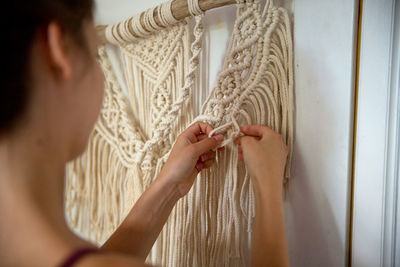 Close-up portrait of woman hand holding curtain