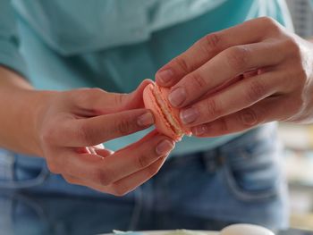 Close-up of woman preparing macaroons