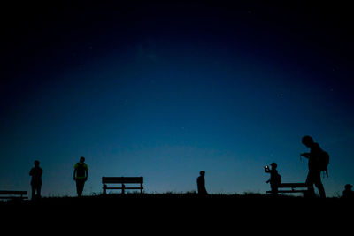 Silhouette people walking at beach