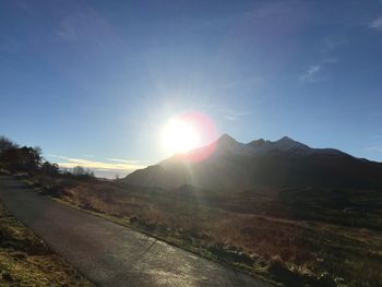 Scenic view of mountains against bright sun