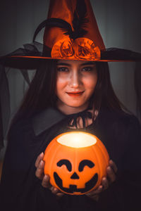 Portrait of smiling woman with illuminated halloween
