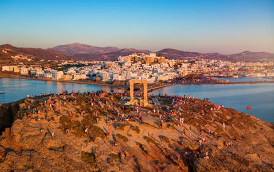 High angle view of townscape by sea against sky