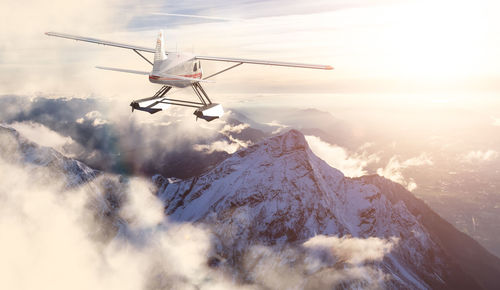 Aerial view of snowcapped mountains against sky