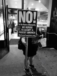 Rear view of woman standing in store