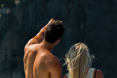 Rear view of friends standing outdoors