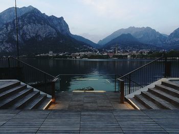 Staircase by lake against sky