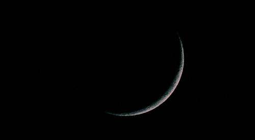 Low angle view of moon in sky at night