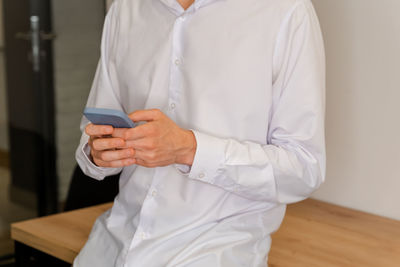 Man using a mobile smart phone. young man and texting on smart phone.