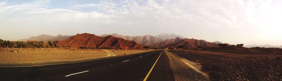 Empty road along barren landscape