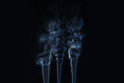 Close-up of smoke emitting from black background