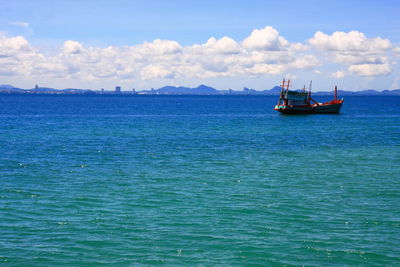 Boat sailing in sea against sky