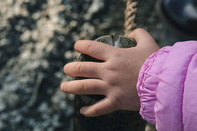 Cropped hand of child on railing