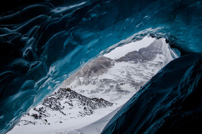 Close-up of frozen sea against mountain