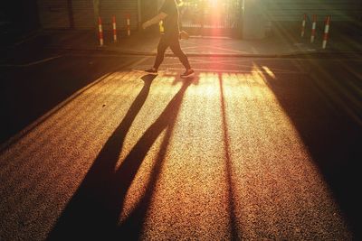 Low section of woman standing on shadow