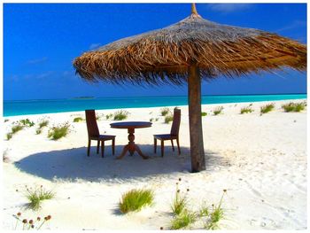 Scenic view of beach against blue sky