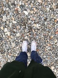 Low section of man standing on stones