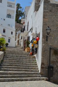 Rear view of man walking on staircase of building