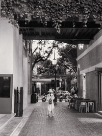 People walking on street amidst buildings