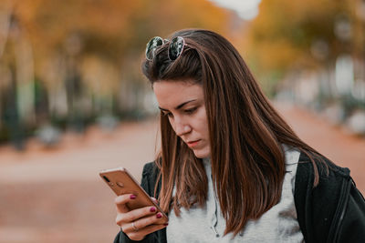 Young woman using mobile phone outdoors