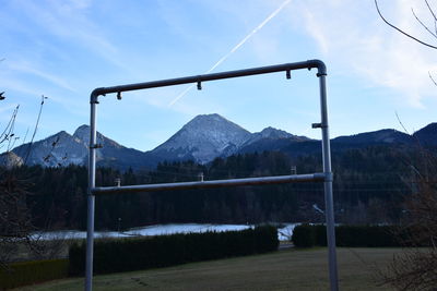 Scenic view of field and mountains against sky