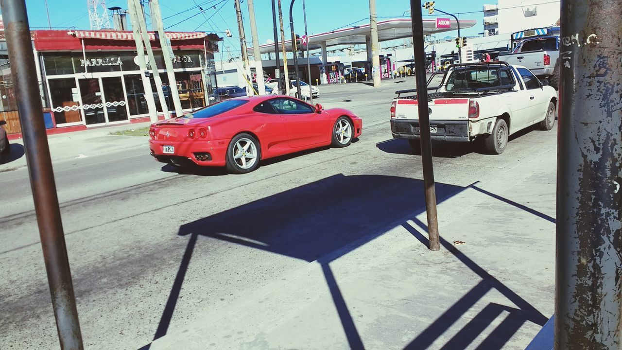 car, land vehicle, transportation, street, mode of transport, red, road, day, outdoors, architecture, no people, city