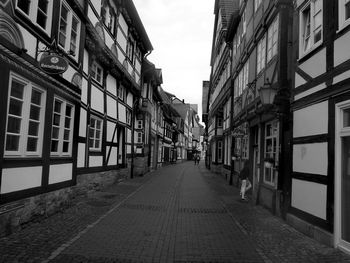 Empty road along built structures