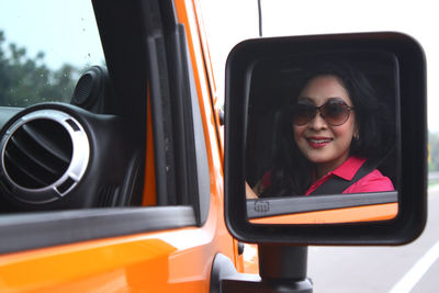 Portrait of young woman in car