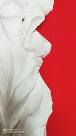 Close-up of statue against red background