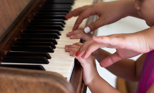 Midsection of woman playing piano