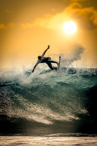 Young surfer with with wetsuit enjoying big waves in tenerife canary islands sporty boy riding surf 