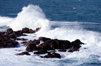 Waves splashing on rocks at shore