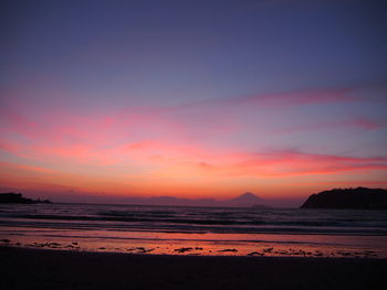 Scenic view of beach against sky during sunset