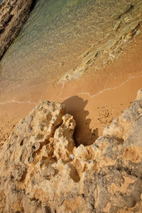 High angle view of rocks on sand at beach