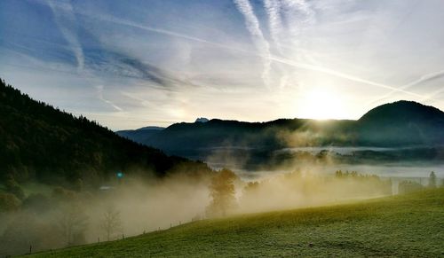 View of landscape against cloudy sky during sunset