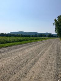 Empty road along countryside landscape