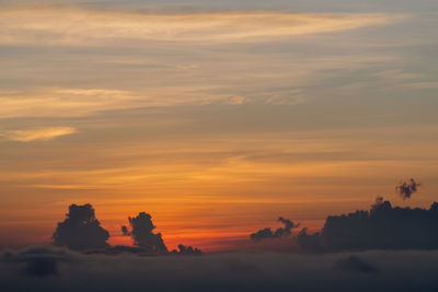 Scenic view of silhouette landscape against orange sky