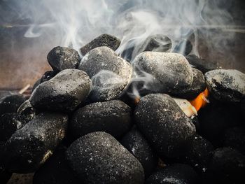 Close-up of smoke emitting from coals