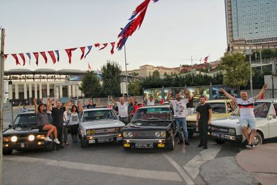 Vehicles on road against buildings in city