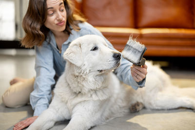 Woman with dog sitting outdoors