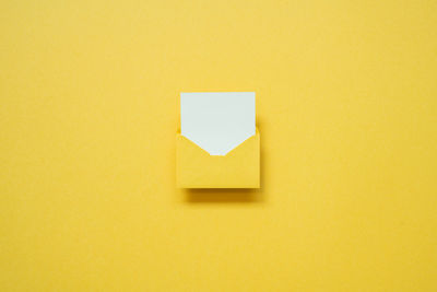 Directly above shot of adhesive note on yellow background