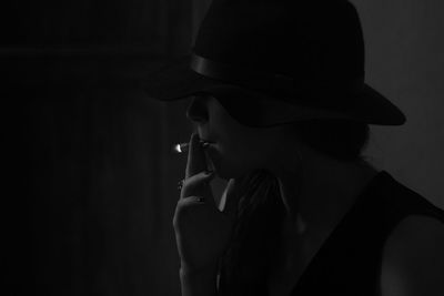 Man smoking cigarette in darkroom