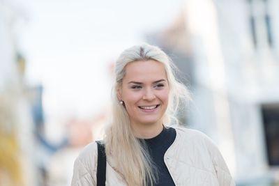 Smiling young woman looking away