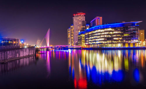 Illuminated city at night in manchester england . sanflord quays media city