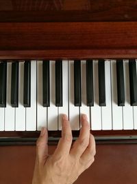 Close-up of hands playing piano