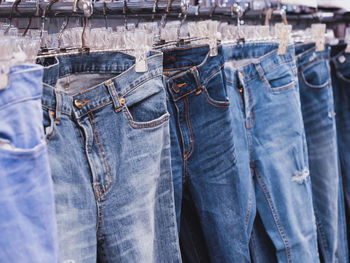 Jeans for sale hanging at store