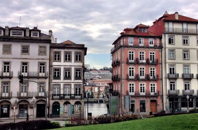 Buildings against cloudy sky