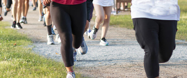 Low section of man running on grassland