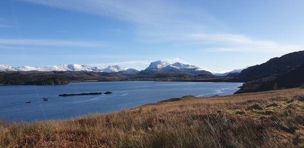 Scenic view of lake and mountains against sky