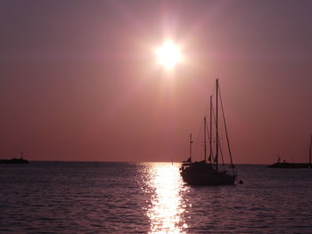 Sailboat sailing on sea against sky during sunset umag