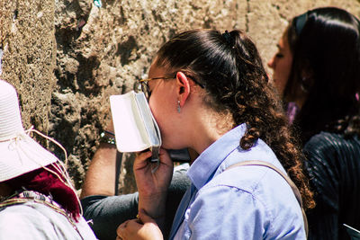 Portrait of a young woman drinking outdoors